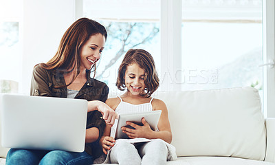 Buy stock photo Technology, mother on laptop and helping daughter on tablet sitting on sofa in the living room of their home. Social media or connectivity, networking or streaming and woman with child happy on couch