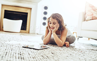 Buy stock photo Child, tablet and living room on floor at house for education by learning on digital technology. Happy, girl and reading on ebook with internet for research, information and literacy for knowledge