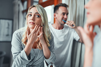 Buy stock photo Shot of a young couple getting ready together in the bathroom at home