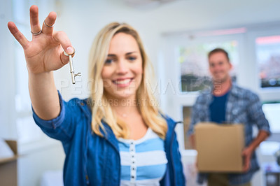 Buy stock photo Portrait of a young woman holding the key to her new house
