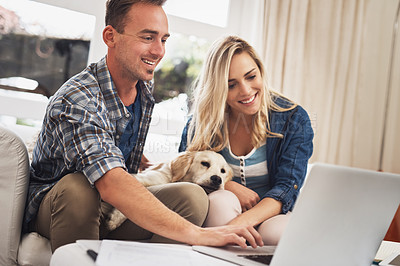 Buy stock photo Shot of a young couple doing their finances together at home