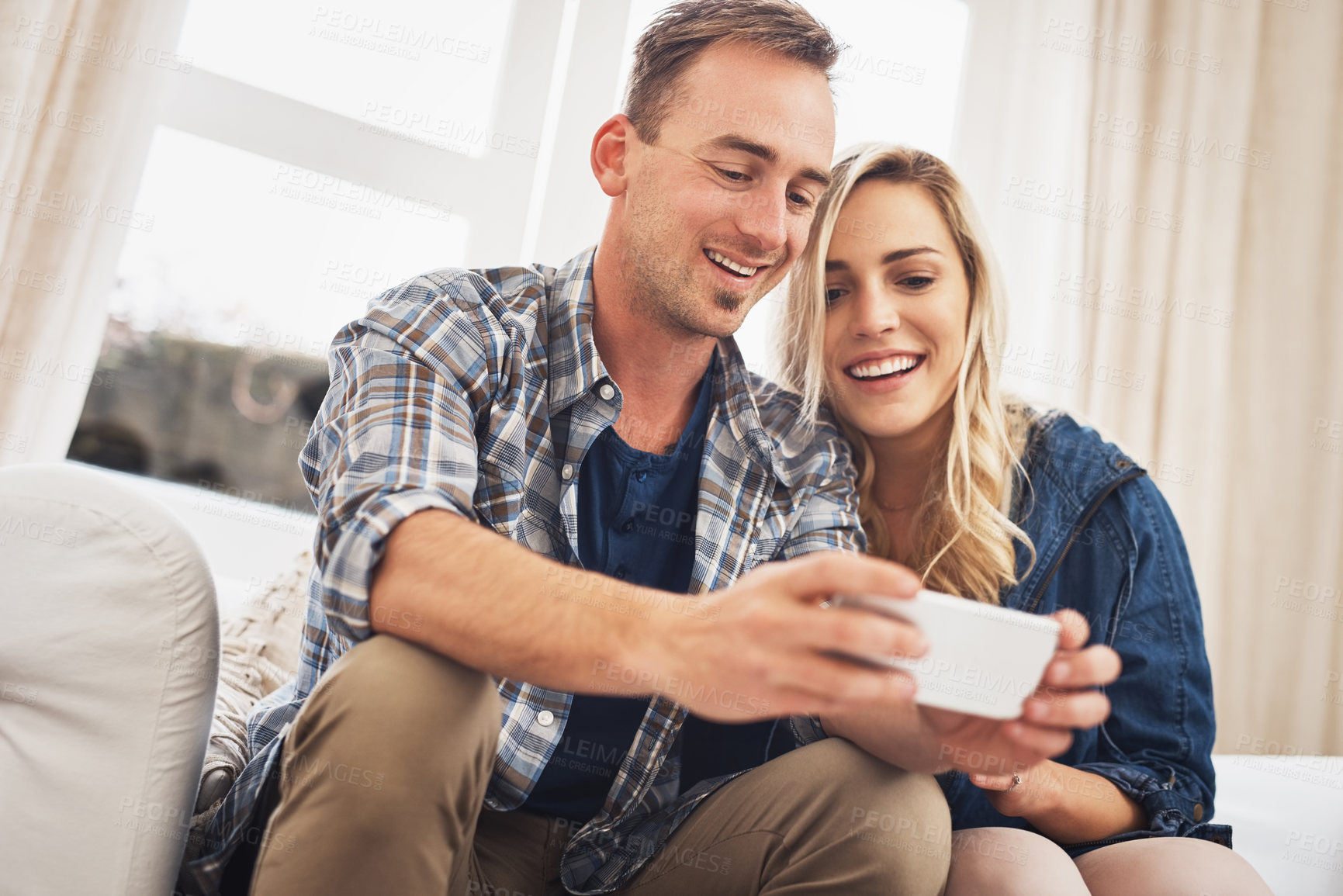 Buy stock photo App, gaming and phone with couple on sofa in living room of home together for bonding or fun. Happy, love or smile with gamer man and woman in apartment for online entertainment or video streaming