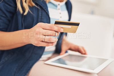 Buy stock photo Closeup shot of a woman making a credit card payment on a digital tablet at home