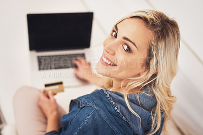 Buy stock photo Portrait of a young woman making a credit card payment on a laptop at home