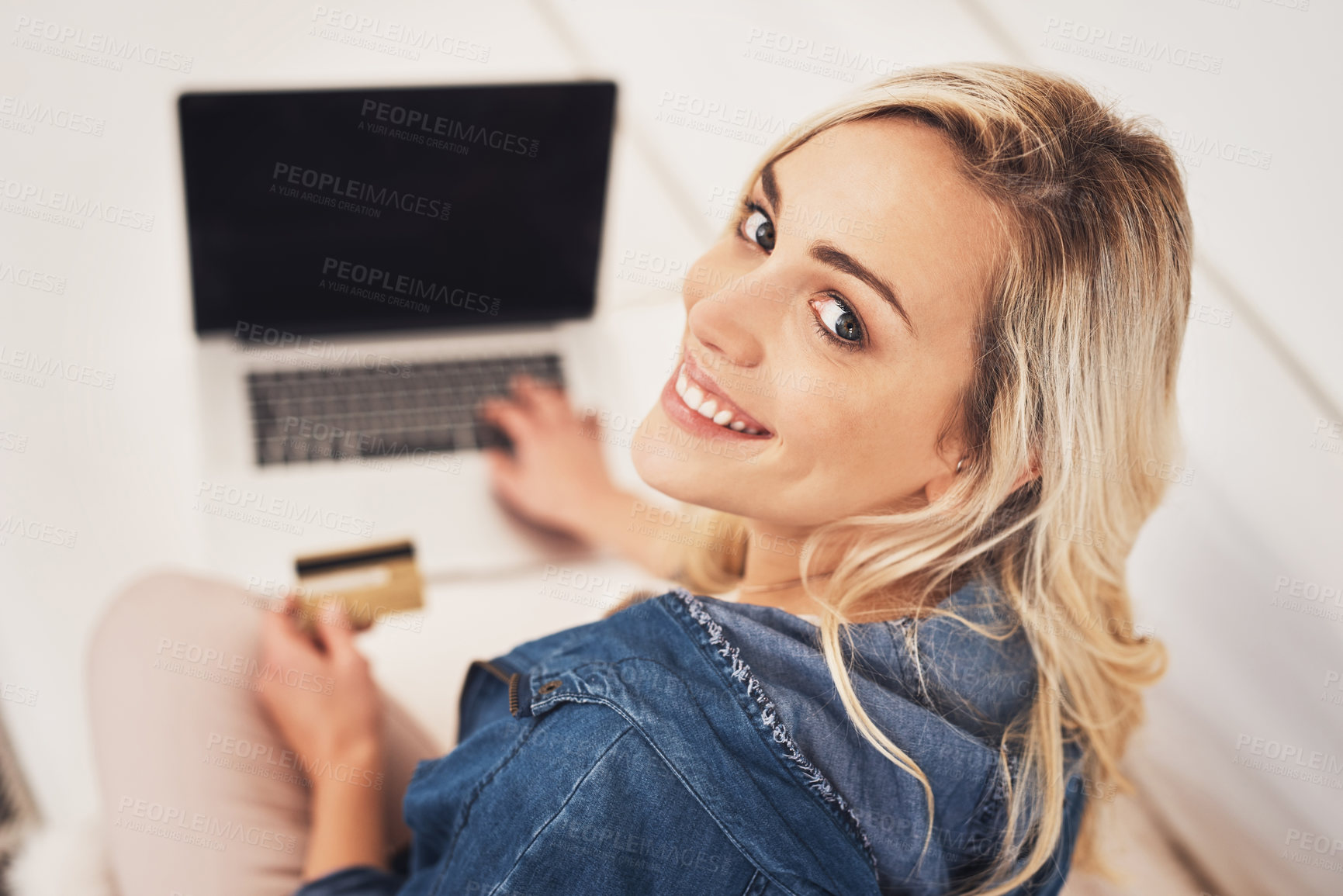 Buy stock photo Portrait of a young woman making a credit card payment on a laptop at home