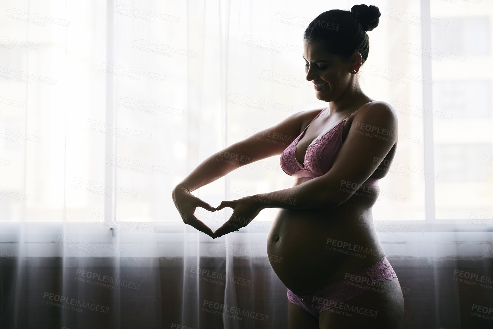 Buy stock photo Cropped shot of an attractive young pregnant woman standing in her bedroom at home