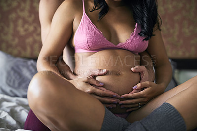 Buy stock photo Pregnancy, couple and hands on abdomen for love, touch and safety with care in home. Future parents, pride or woman in underwear for growth, maternity or hug for protection or baby kicking in bedroom