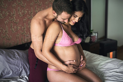 Buy stock photo Pregnant, woman and man with love on bed in home for bonding with baby and excited for parenting. Couple, happy people and cuddle in bedroom with lingerie, maternal support and future family in house