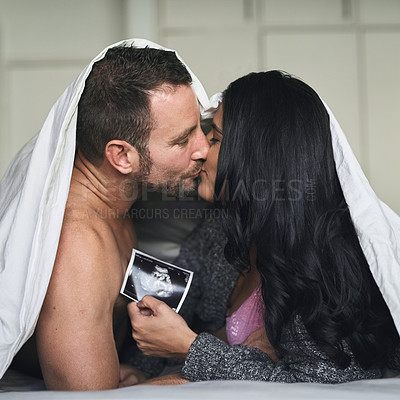 Buy stock photo Home, couple and kiss with sonogram of ultrasound, progress and growth for baby development. Bedroom, parents and pregnant woman with fetus scan for pregnancy, motherhood and bonding with partner