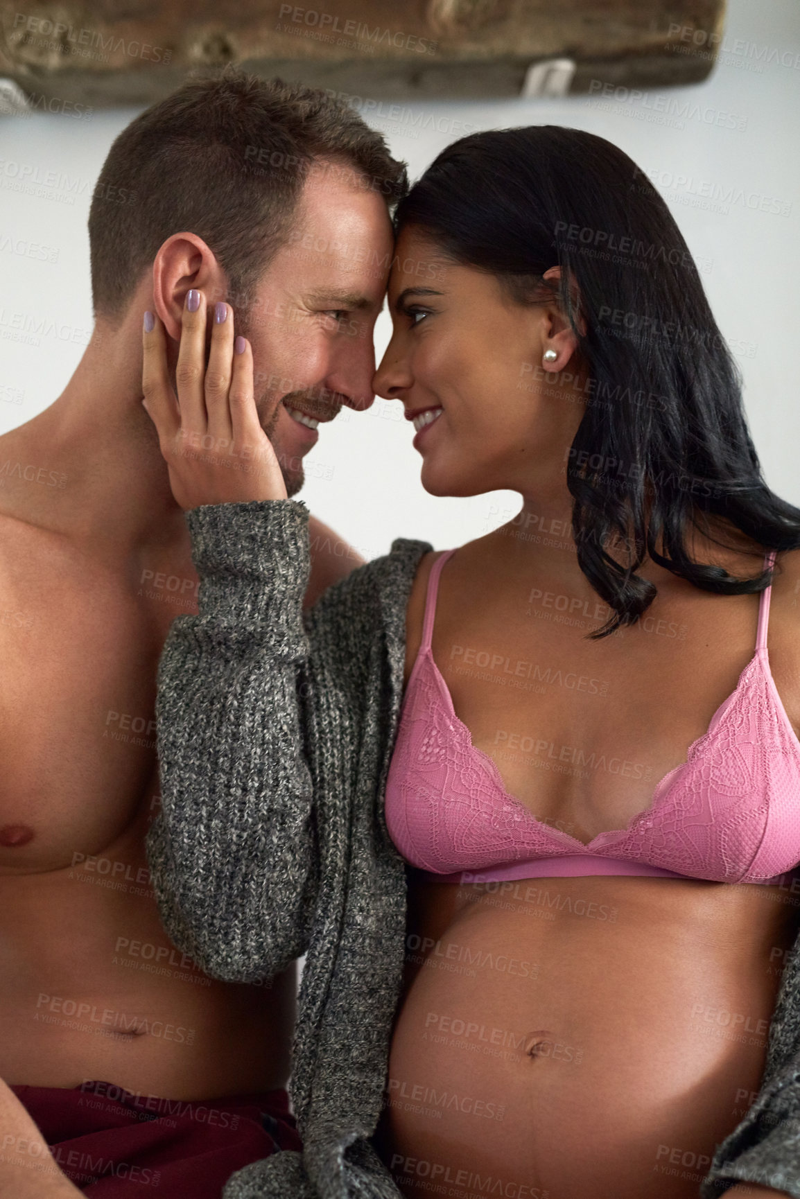 Buy stock photo Pregnancy, happy couple and forehead touch in home for love, prenatal care and maternity. Man, pregnant woman and support for future family, romance and commitment to partner in underwear together