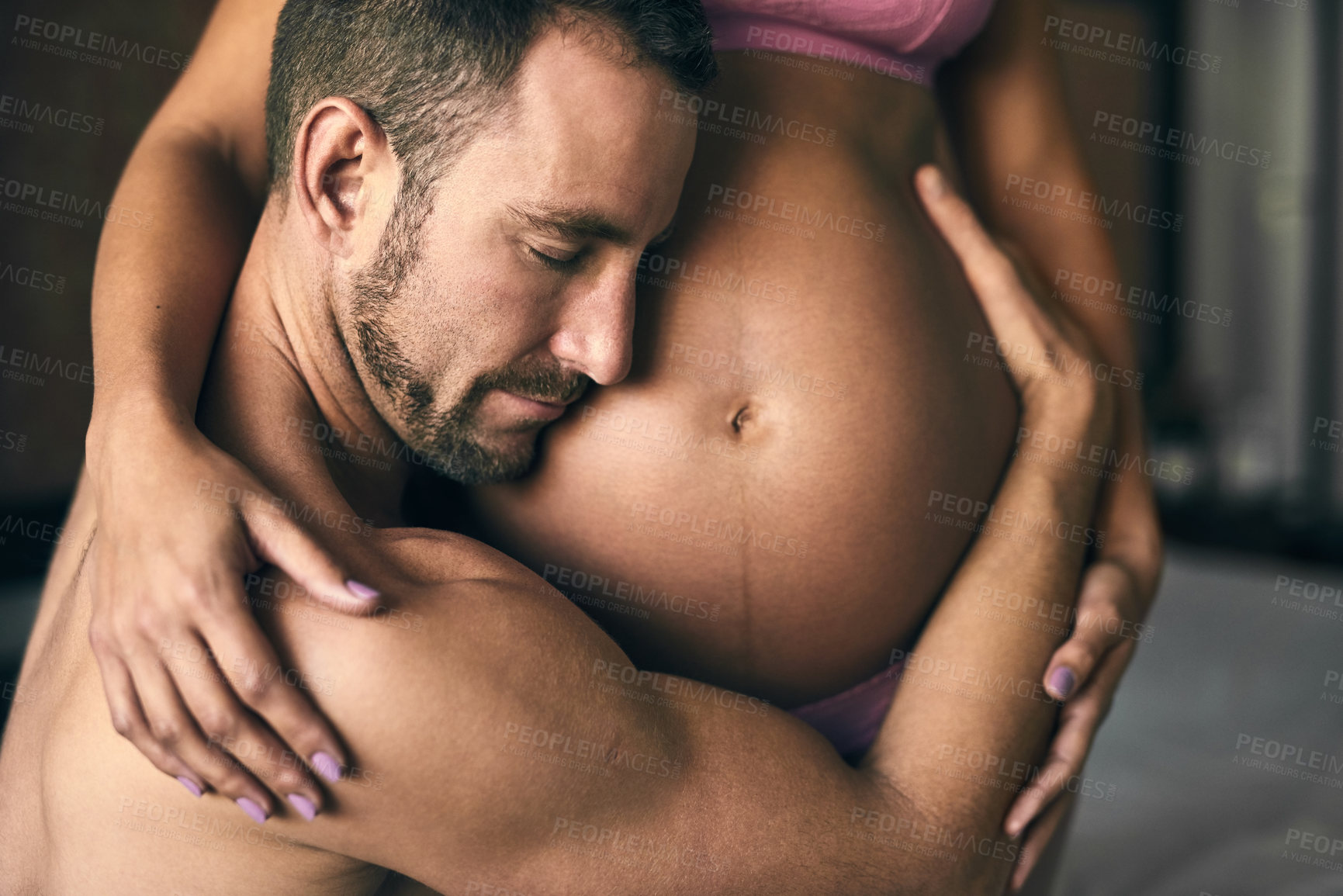 Buy stock photo Pregnant, couple and listening to tummy in bedroom for bonding with baby, love and feeling kick. Maternal support, people and excited for parenting in house with lingerie, heartbeat and embrace mom