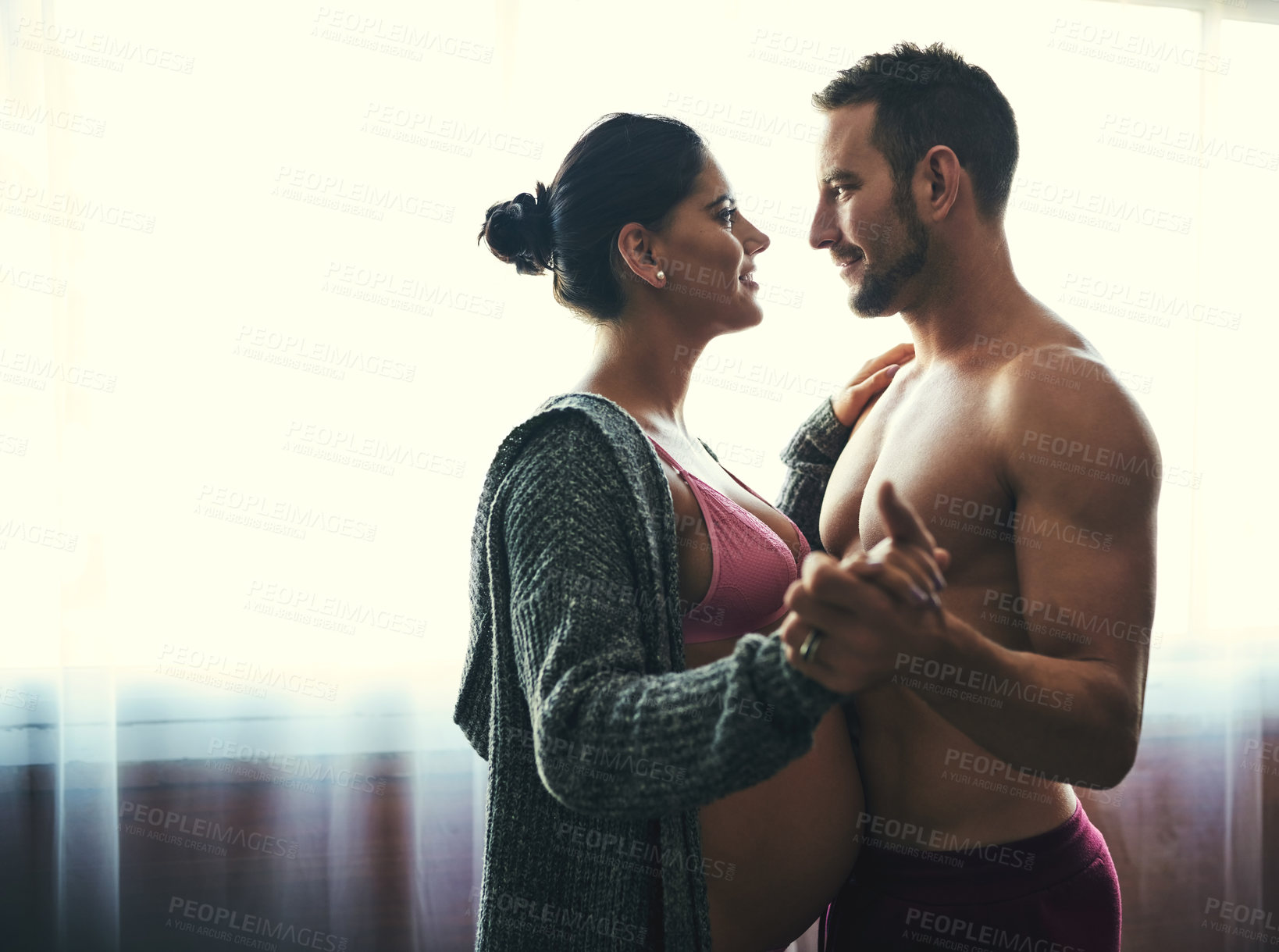 Buy stock photo Couple, pregnant woman and dance in bedroom for prenatal care, bonding and love of pregnancy development. Man, wife and stomach with underwear, healthy maternity and family intimacy at house