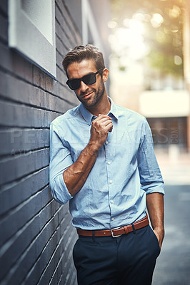 Buy stock photo Sunglasses, fashion and man by brick wall in city with trendy, stylish and classy outfit. Accessory, handsome and male public relations officer with elegant shirt and pants with confidence in town.