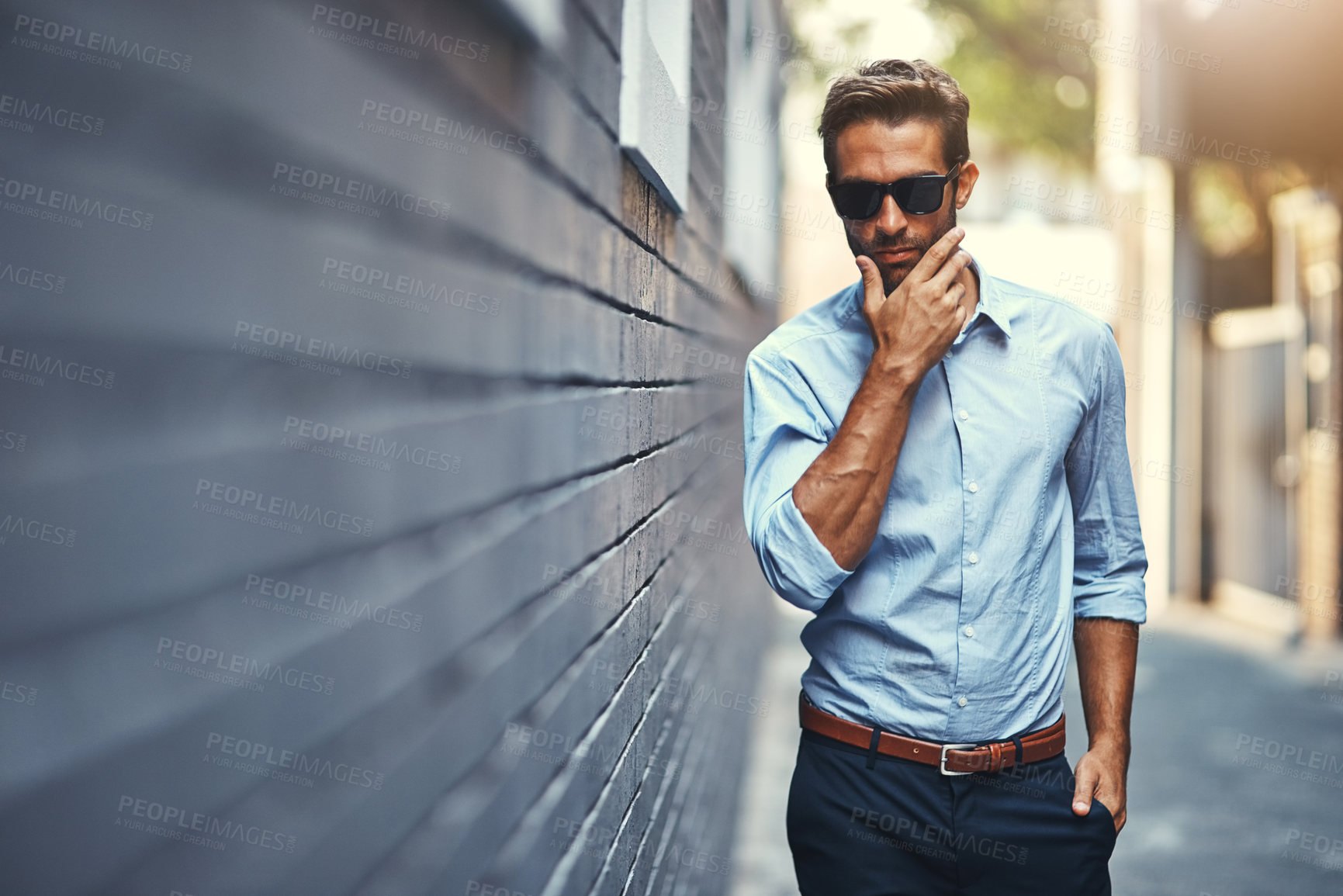 Buy stock photo Sunglasses, style and portrait of man by brick wall in city with trendy, business and classy outfit. Accessory, handsome and male architect with elegant shirt and pants with confidence in town.