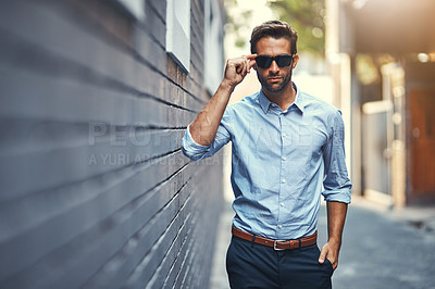 Buy stock photo Sunglasses, fashion and portrait of man by brick wall in city with trendy, stylish and classy outfit. Accessory, handsome and person with elegant shirt and pants for style with confidence in town.