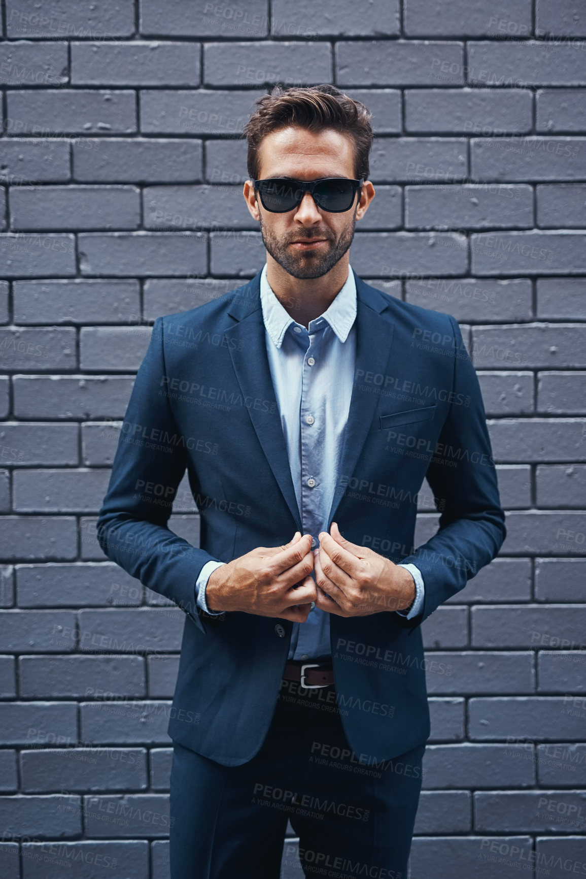Buy stock photo Businessman, bricks and trendy with suit and confident for fashion, clothing or clothes and cool. Male lawyer, backdrop and stylish or edgy for career with corporate, funky with sunglasses in Seattle