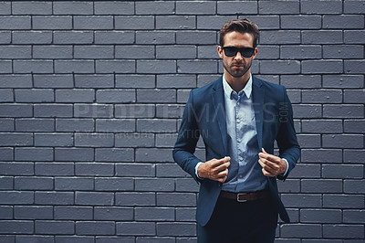 Buy stock photo Confident, man and wall in suit with sunglasses for fashion, style and trendy in outdoor. Male person, pride and project manager for work, corporate and career on grey background in New York City