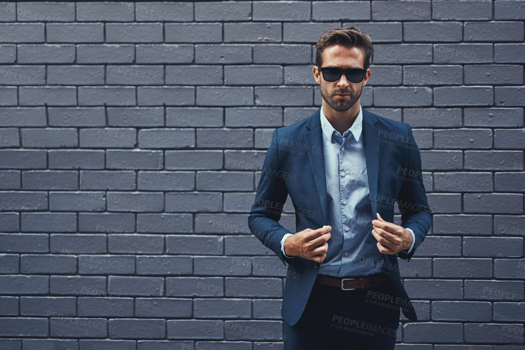 Buy stock photo Confident, man and wall in suit with sunglasses for fashion, style and trendy in outdoor. Male person, pride and project manager for work, corporate and career on grey background in New York City