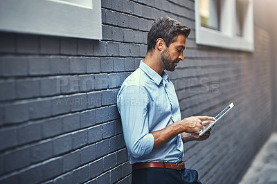 Buy stock photo Business man, tablet and web research, reading email or info online on a wall in urban city. Serious, digital tech and person scroll on app or consultant networking outdoor on social media in street