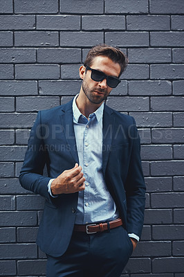 Buy stock photo Male model, wall and fashion with suit or confident for clothing, sunglasses or trendy and cool. Businessman, backdrop and stylish or formal for career with corporate, lawyer with hands in Chicago
