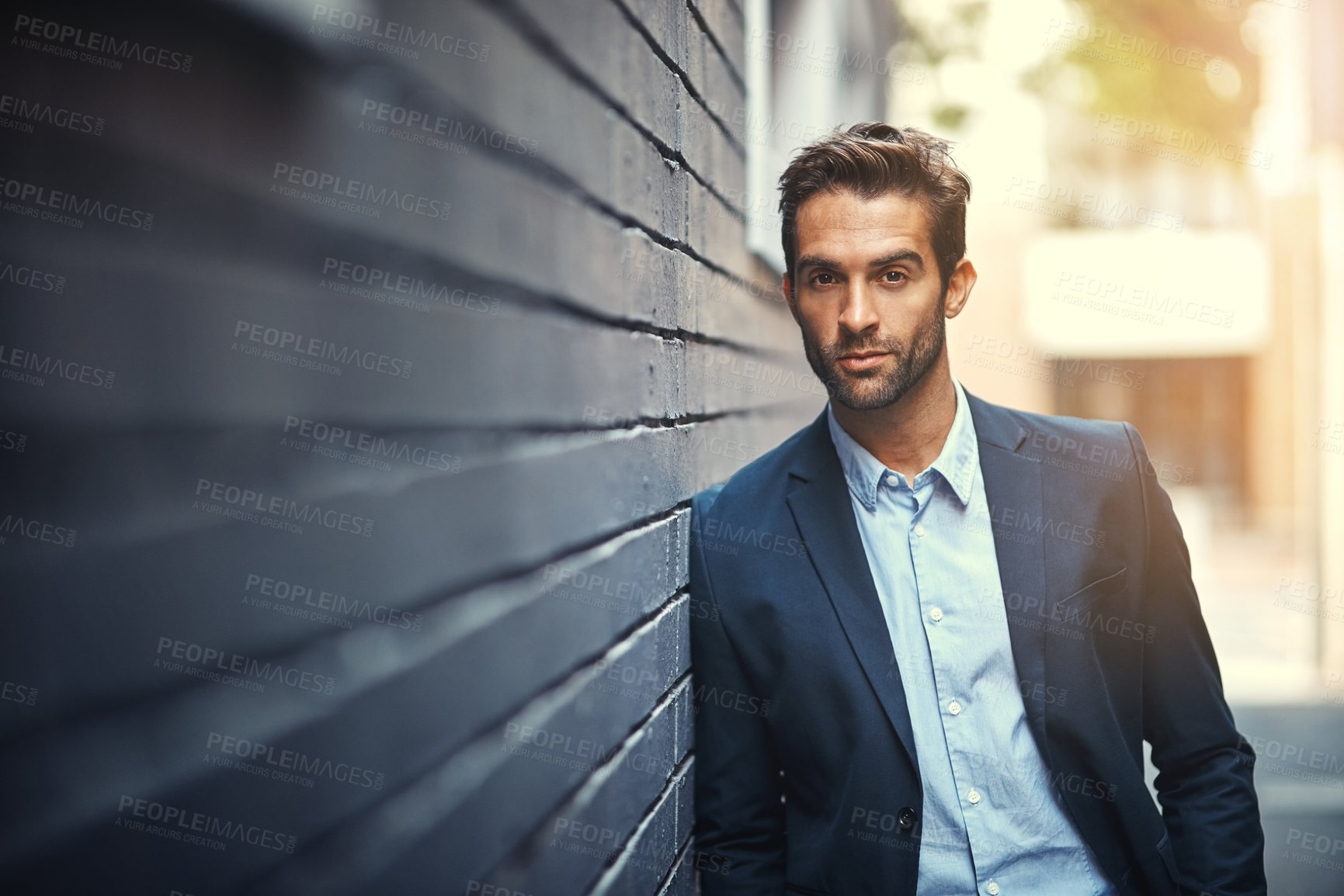 Buy stock photo Serious, businessman and portrait in city by wall for corporate fashion, trendy and stylish suit. Male entrepreneur, professional and confident in street for travel to work or company and outdoors.