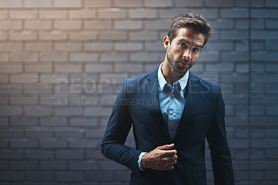 Buy stock photo Portrait of a handsome young businessman standing against a grey facebrick wall