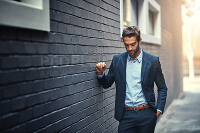 Buy stock photo Confident, businessman and thinking in city by wall for corporate fashion, trendy and stylish suit. Male entrepreneur, professional and thoughts in street for commute to work or company and outdoor.