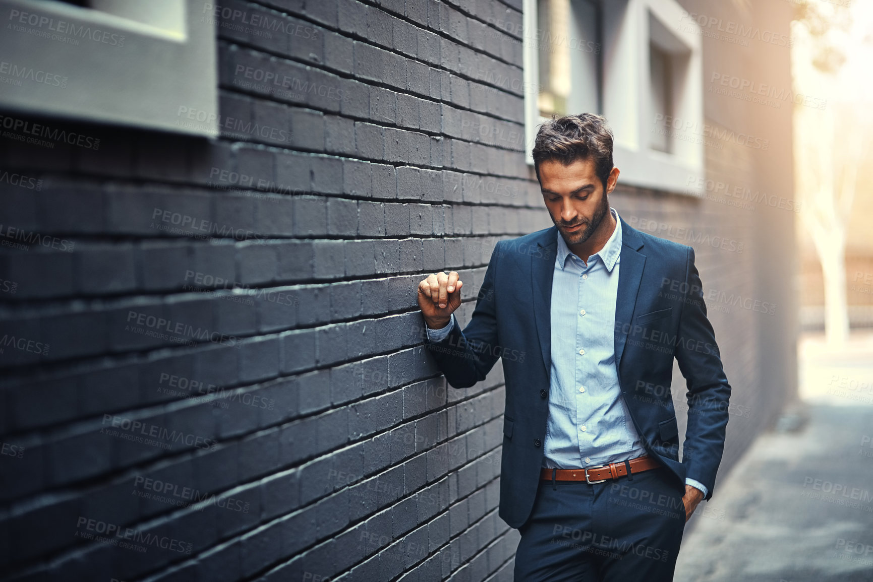 Buy stock photo Confident, businessman and thinking in city by wall for corporate fashion, trendy and stylish suit. Male entrepreneur, professional and thoughts in street for commute to work or company and outdoor.