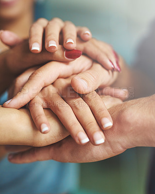 Buy stock photo Cropped shot of a group of colleagues joining their hands together in unity