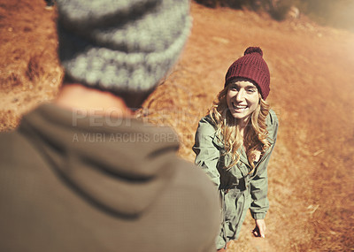 Buy stock photo Cropped shot of a man giving his girlfriend a hand while out hiking