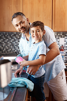 Buy stock photo Child, portrait and dad washing dishes in kitchen together for learning housekeeping at home. Teaching, hygiene and father with boy kid cleaning cup with cloth for chores and bonding at house.