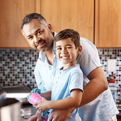 Buy stock photo Kid, portrait and father washing dishes in kitchen together for learning housekeeping at home. Teaching, hygiene and dad with boy child cleaning cup with cloth for chores and bonding at house.