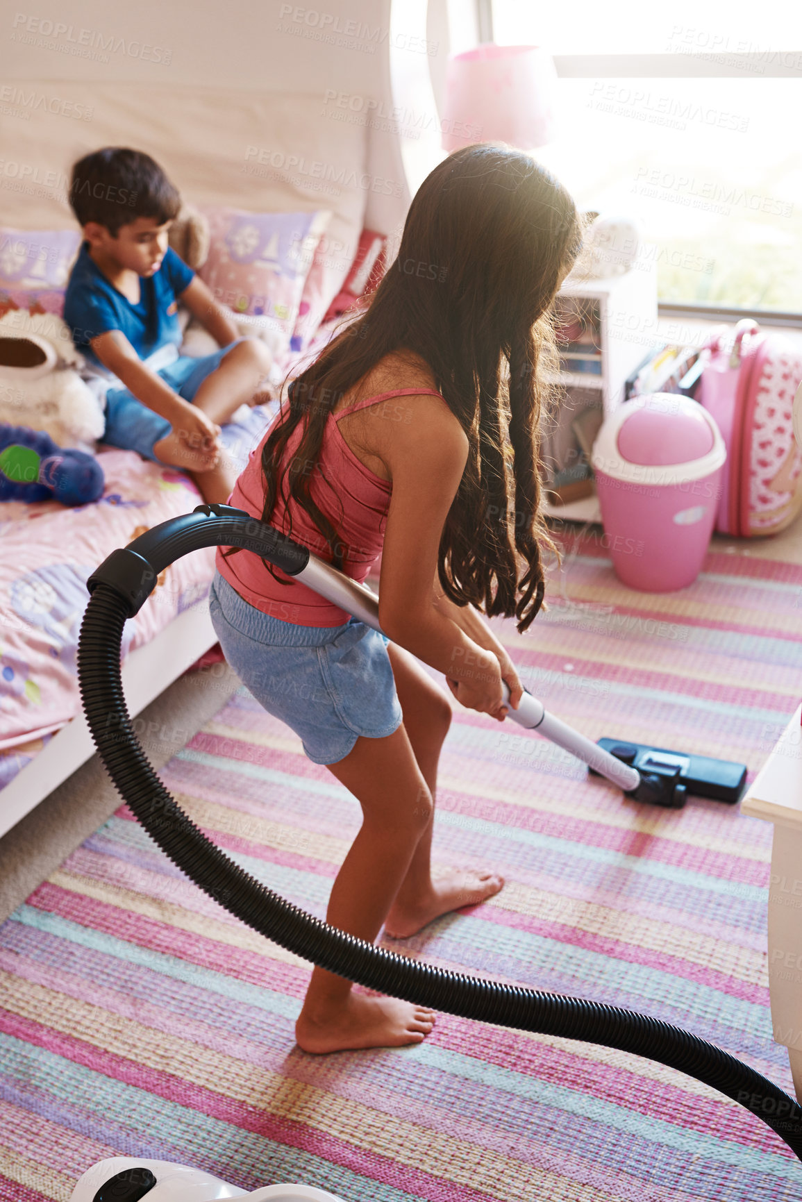 Buy stock photo Girl, carpet and vacuum for cleaning in bedroom, house and at home for child development and growth. Lens flare, child and machine for responsible housekeeping, learning and chores for hygiene