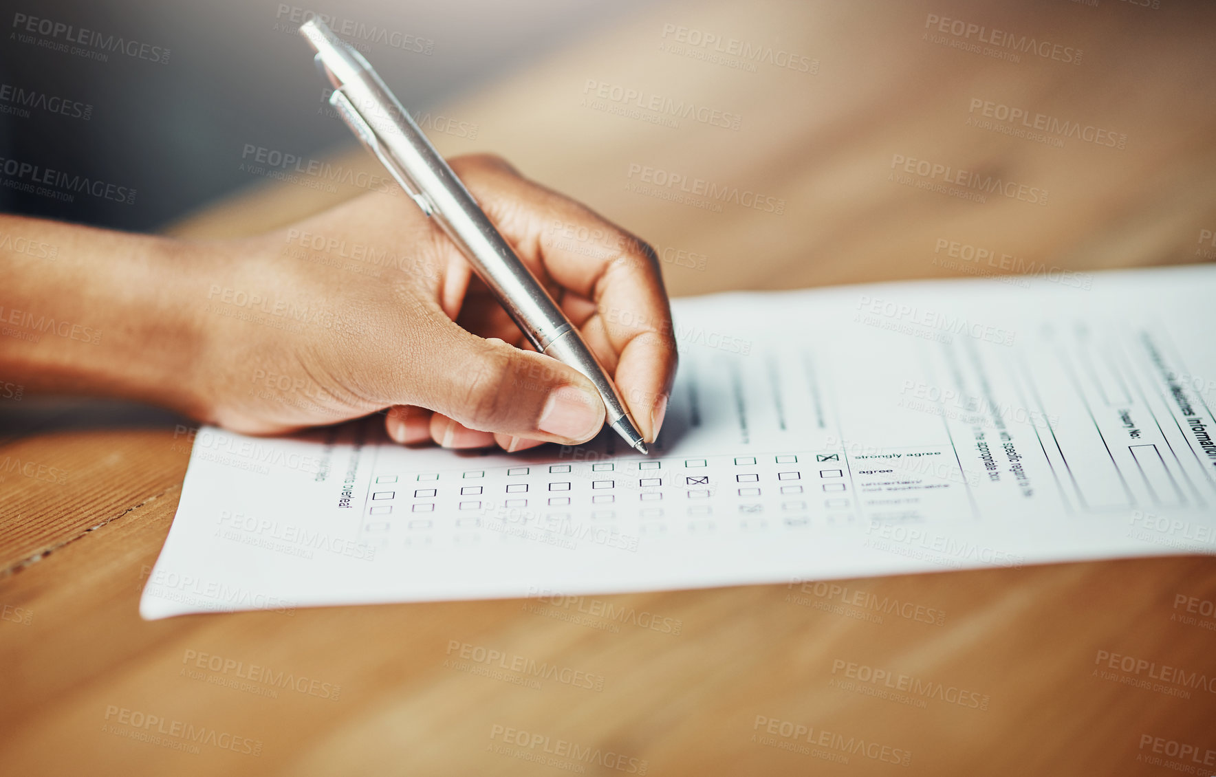 Buy stock photo Closeup of a female hand filing in paperwork for a formal application or survey. A woman writing on a form applying for a financial loan, completing a list or questionnaire.