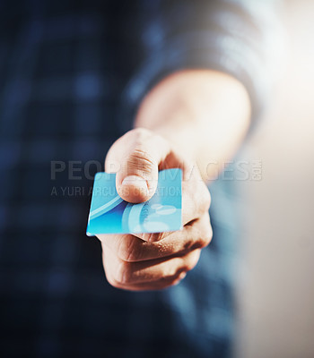 Buy stock photo Closeup of a man buying or purchasing with a credit card in hand. Caucasian male getting paying bills with a debit card, ready to shop. Casual guy paying a shop cashier for commerce purchase.
