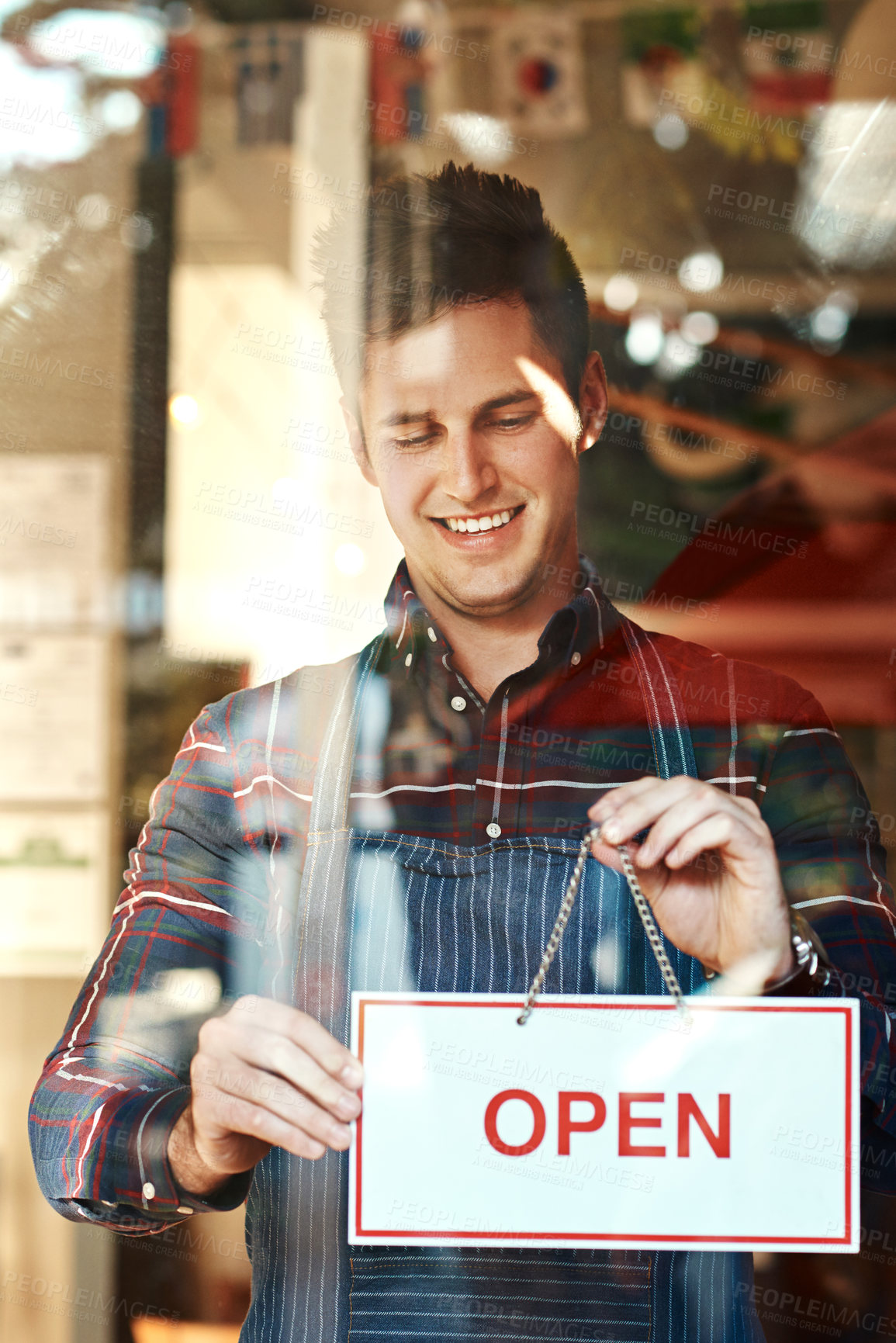Buy stock photo Open sign, happy and man with startup success, entrepreneur and service with restaurant, coffee shop and smile. Male person, employee and business owner with billboard, opening store and welcome