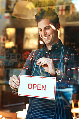 Buy stock photo Open sign, smile and man with business, startup success and service with restaurant, window and coffee shop. Male person, employee and entrepreneur with billboard, poster and opening retail store