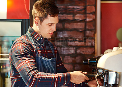 Buy stock photo Serious, man and barista with coffee machine for brewing latte in cafe for customer service and retail. Male person, waiter and espresso drink preparation for luxury beverage at restaurant or bistro