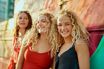 Buy stock photo Cropped portrait of three attractive young girlfriends having a great time out in the city