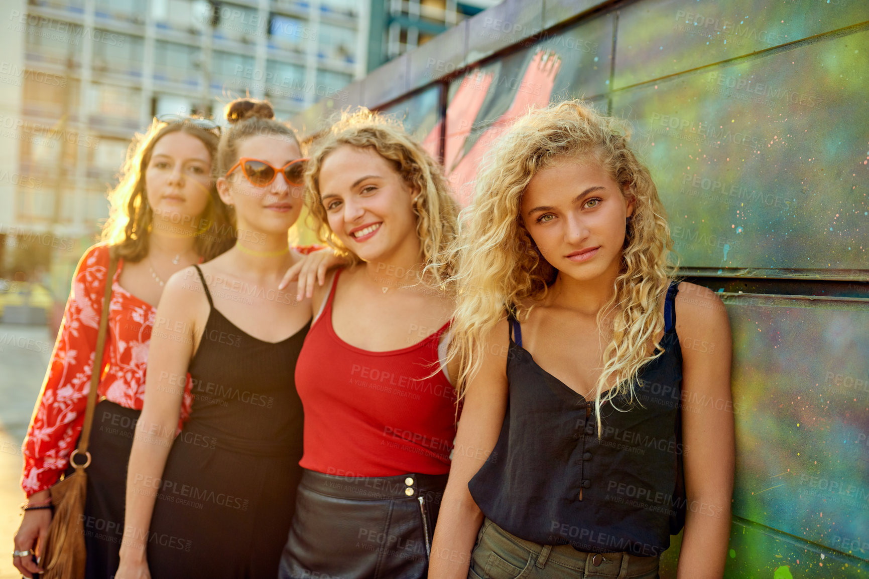 Buy stock photo Cropped portrait of a group of attractive young girlfriends having a great time out in the city