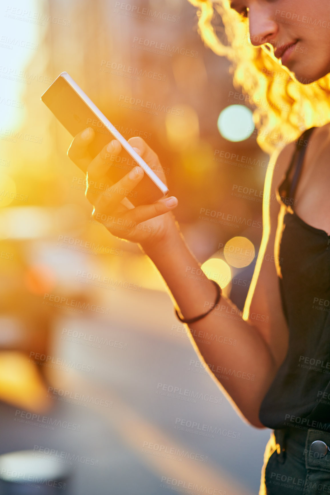 Buy stock photo Girl, hand and city with phone in street for social media, communication or network connection. Closeup, female person or user on mobile smartphone for online browsing, chatting or sunset in town