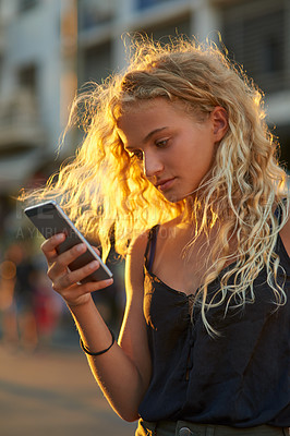 Buy stock photo Girl, city and street with phone for social media, communication or network connection. Young, female person or user on mobile smartphone for online browsing, chatting or texting in an urban town