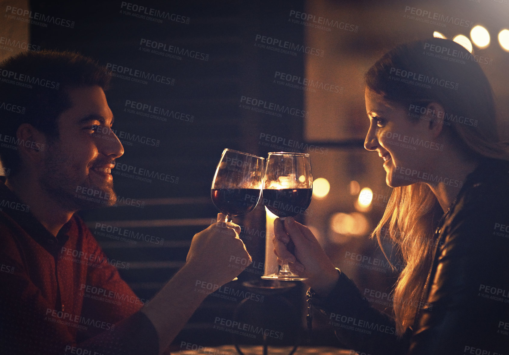 Buy stock photo Cropped shot of a couple celebrating with wine on a date