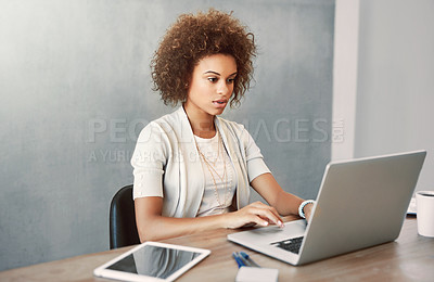 Buy stock photo Cropped shot of an attractive young businesswoman working on her laptop at home
