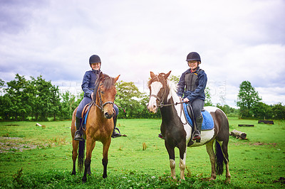 Buy stock photo Shot of two teenage girls going horseback riding on a ranch