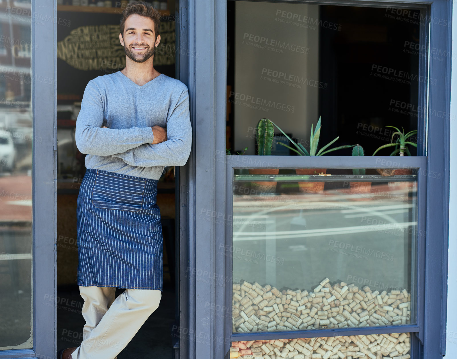 Buy stock photo Smile, small business and portrait of man with arms crossed at cafe for service industry, welcome or working. Happy, entrepreneur and barista with apron at coffee shop entrance, doorway or front door