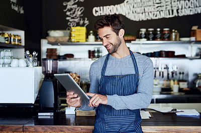 Buy stock photo Small business, coffee shop and man with tablet checking online review, web or reservation in cafe. Networking, smile and restaurant manager, waiter or owner with digital app for service stock report