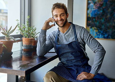Buy stock photo Small business, cafe and man with phone call, apron and relax in coffee shop for networking. Communication, working and restaurant manager, waiter or owner with smartphone, conversation and service
