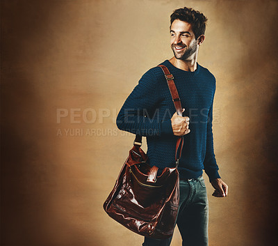 Buy stock photo Smile, thinking and man with bag for fashion isolated on a brown background mockup space in studio. Idea, vision and  person in casual clothes, jeans or laugh for trendy style with leather for travel