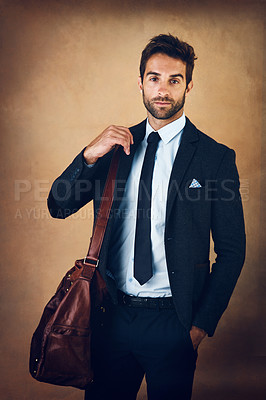 Buy stock photo Bag, portrait and man for corporate fashion with clothes, style and formal wear isolated on brown background. Male person, gentleman and businessman in trendy outfit, class or suit in studio backdrop